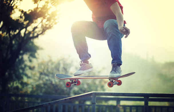 Skateboarder skateboarding at skate park ramp - Fotó, kép