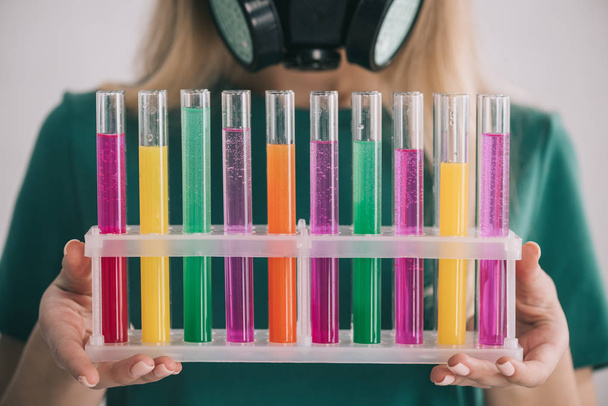 cropped view of woman holding colorful test tubes  - Фото, зображення