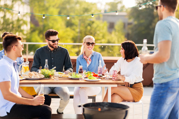 happy friends having bbq party on rooftop - Photo, Image