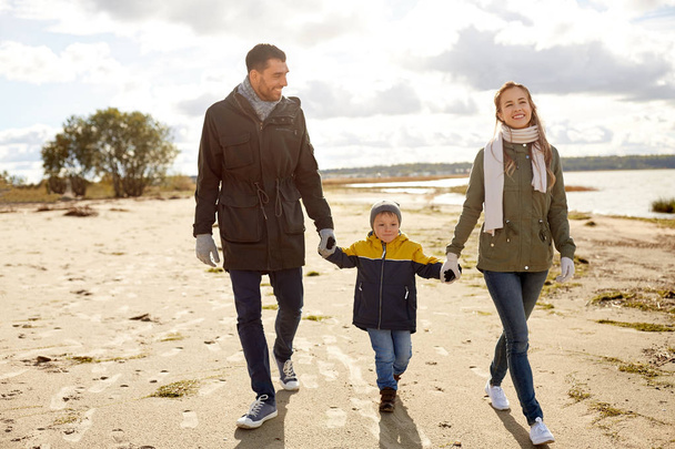 happy family walking along autumn beach - Фото, зображення