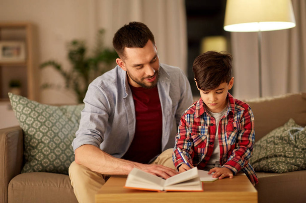 father and son doing homework together - Photo, image