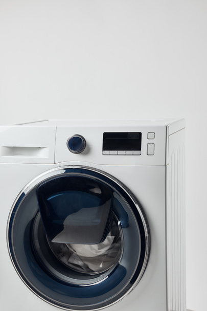 Modern washing machine with black display isolated on grey - Foto, Bild