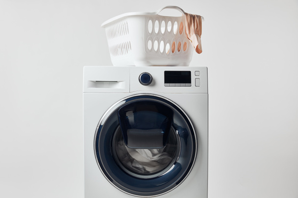Washing machine with laundry basket isolated on grey - Foto, Imagen