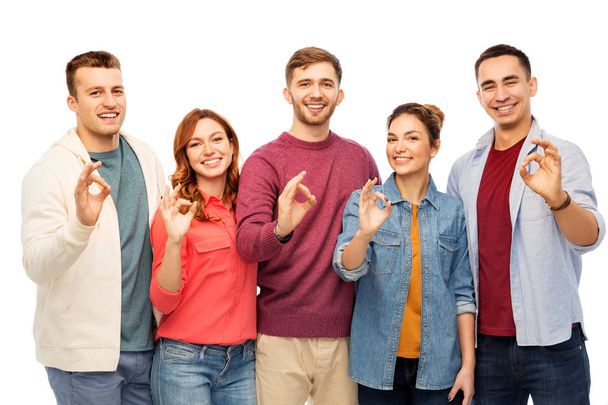 group of smiling friends showing ok hands sign - Foto, Bild