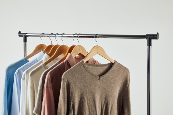 Straight rack, wooden hangers and male clothes isolated on grey - Фото, зображення