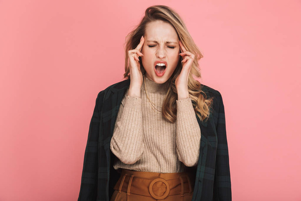 Portrait of stressed blond woman 30s in stylish outfit rubbing t - Photo, Image