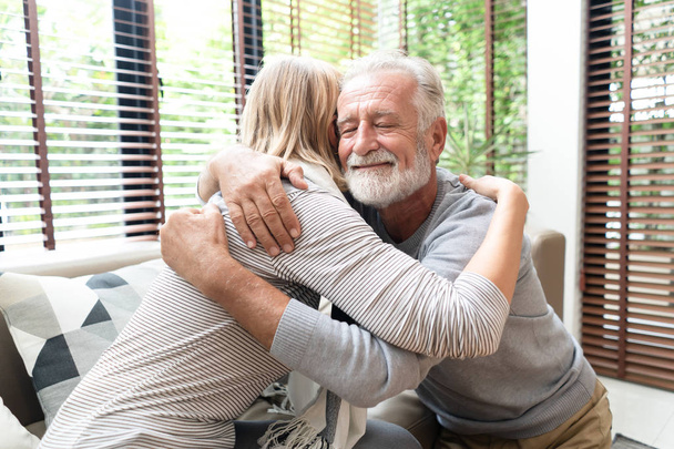 Close-up portrait of a happy senior man embracing his wife in li - Фото, изображение