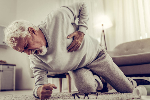 Aging grandfather falling down because of shooting pain in heart - Foto, imagen