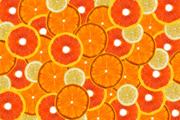 Fruit background made from fresh grapefruit and lemon slices on a white background, overhead view, flatlay.  - Foto, Imagen