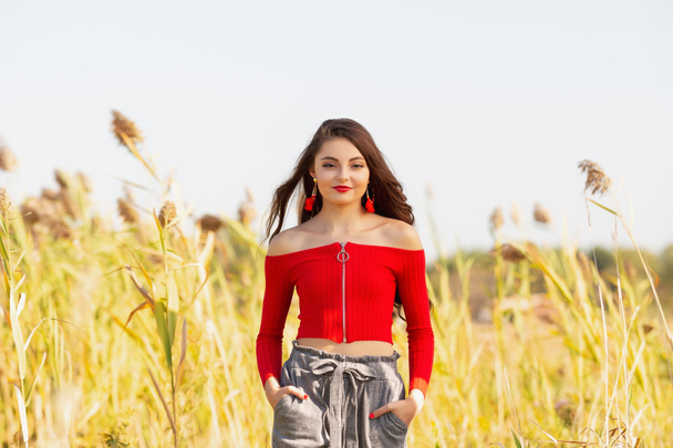 One beautiful female caucasian high school senior girl in red crop top - Photo, Image