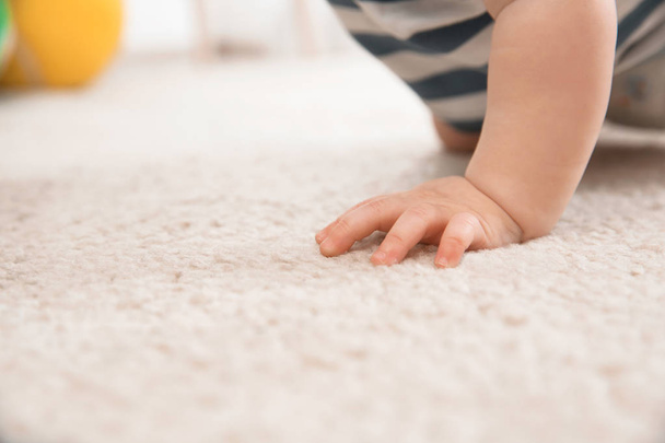 Cute little baby crawling on carpet indoors, closeup with space for text - Foto, Bild