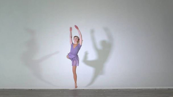 4k - Attractive ballerina dancing and performs pirouette isolated - Photo, Image