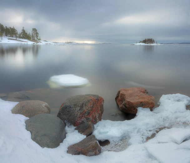 Spring ice floes on the shore of lake Ladoga. Karelia. Russia - 写真・画像