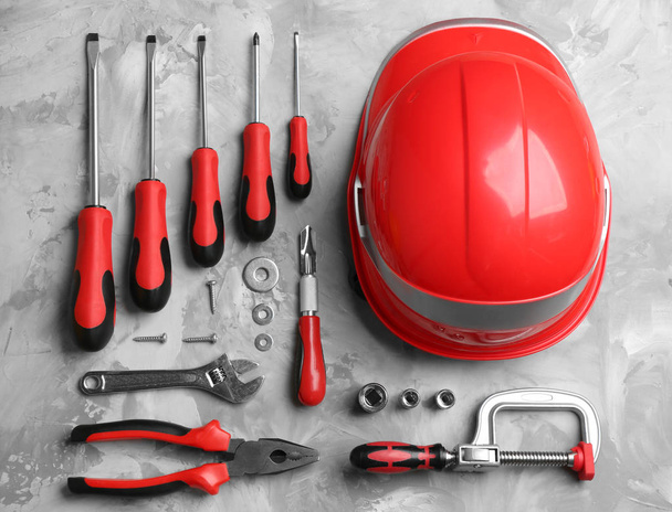 Flat lay composition with different construction tools on grey background - Fotoğraf, Görsel