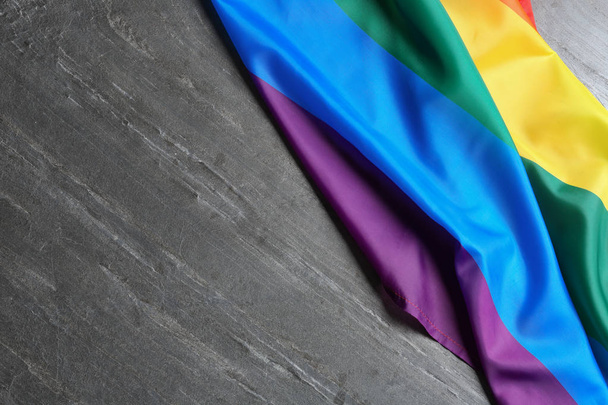 Bright rainbow gay flag on table, top view with space for text. LGBT community - 写真・画像