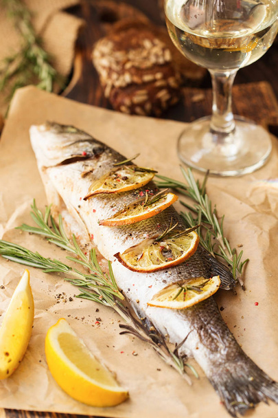 Oven-baked Sea bass with lemon and herbs. fish, baked entirely - Фото, зображення
