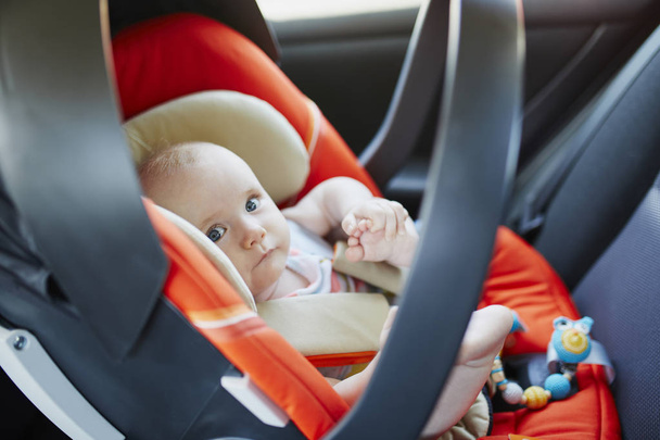 baby girl in modern car seat - 写真・画像