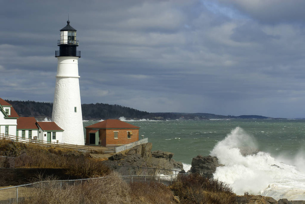 Sunlight Breaks Through Clouds oin Lighthouse with Huge Waves Br - Photo, Image