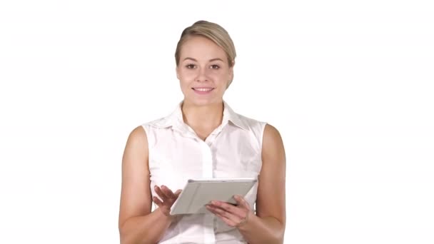 Young smiling business woman with tablet computer turning pages and looking in to the camera on white background. - Filmati, video