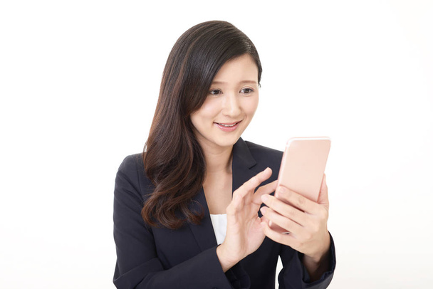 Business woman looking at smart phone - Фото, зображення