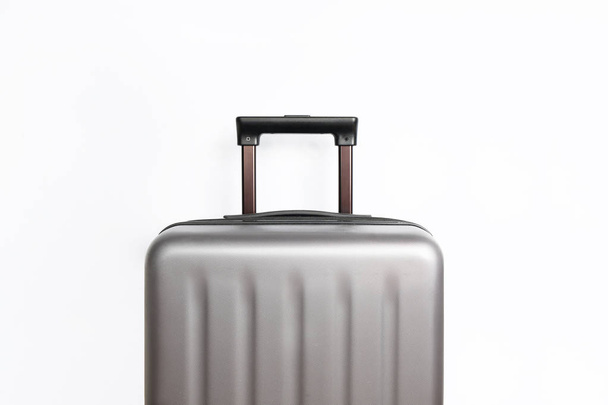 Suitcase on light grey background with place for text. Minimal creative travel concept - Zdjęcie, obraz