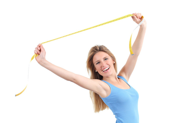 Pretty woman happy stretching a measure tape - Foto, imagen
