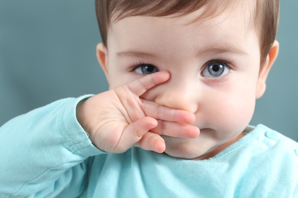 Close up of a baby girl looking at camera with a big blue eyes - Foto, Imagem