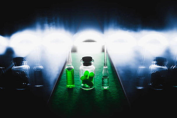 liquid and pill drug production concept. artistic dark filter. low key photo - Фото, изображение