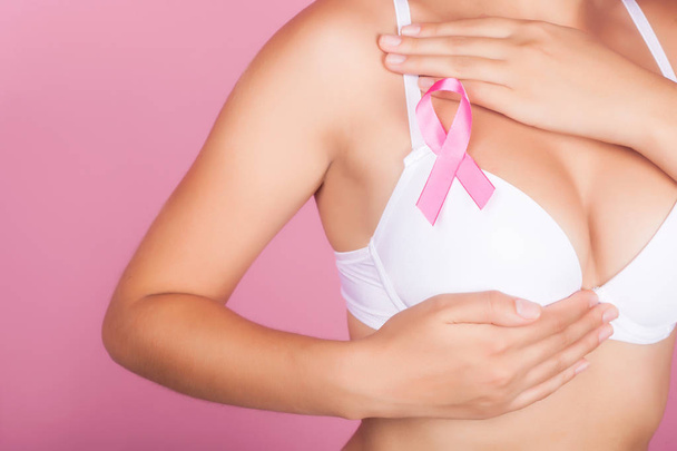 healthcare and medicine concept - woman with pink breast cancer awareness ribbon - Foto, afbeelding