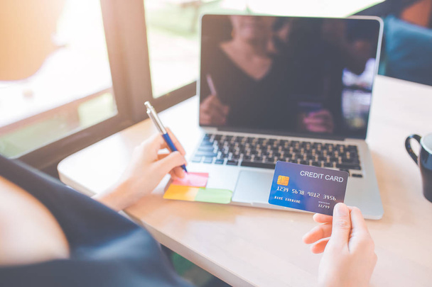 Business women use credit cards to shop online. - Photo, Image