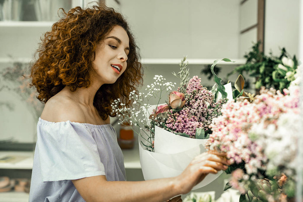 Beautiful young worker of floral shop feeling inspired and creative - Valokuva, kuva