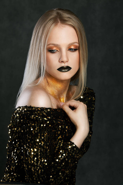 Fashion portrait of young caucasian model with golden sparkles on her neck. - Photo, image