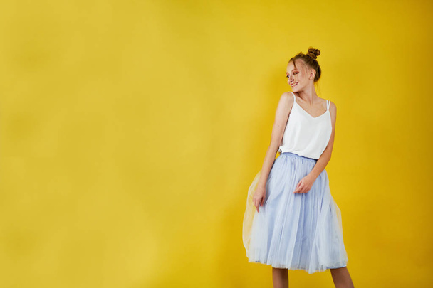 young girl on a yellow bright background. beautiful makeup, bright image, place for text - Fotoğraf, Görsel