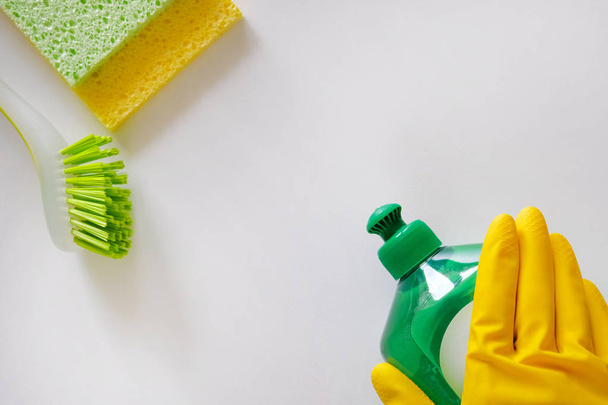 Cleaning service concept. Cleaning set with green tools on light background. Top view cleaning accessories, copy space. - Photo, Image
