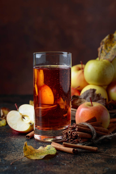Glass of apple juice or cider with juicy apples and cinnamon sti - Photo, Image
