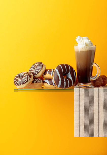 Chocolate donuts and coffee cocktail with cream. - Фото, изображение