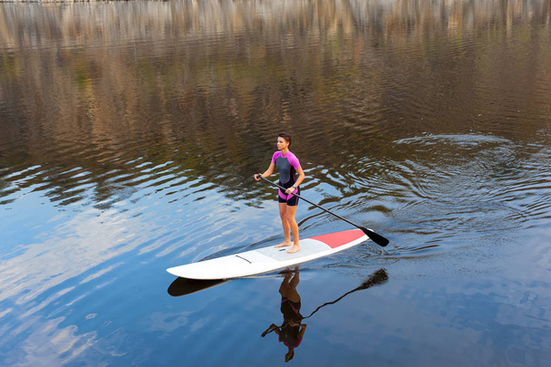Young athletic girl involved in water sports - 写真・画像
