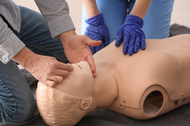People learning to perform CPR at first aid training course - Foto, imagen