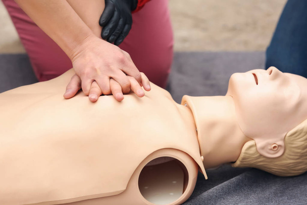 Man learning to perform CPR at first aid training course - 写真・画像