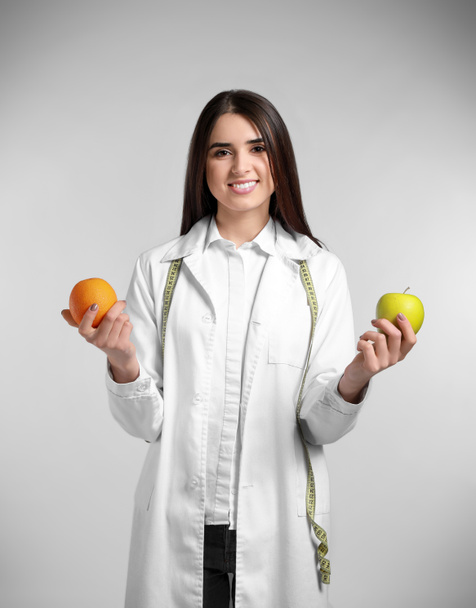Portrait of female nutritionist on light background - Photo, Image