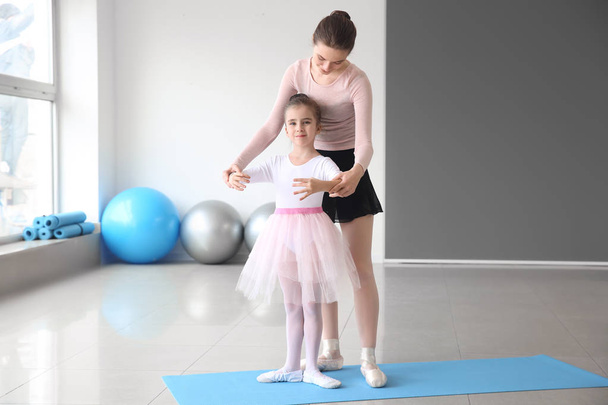 Little ballerina training with coach in dance studio - Fotografie, Obrázek