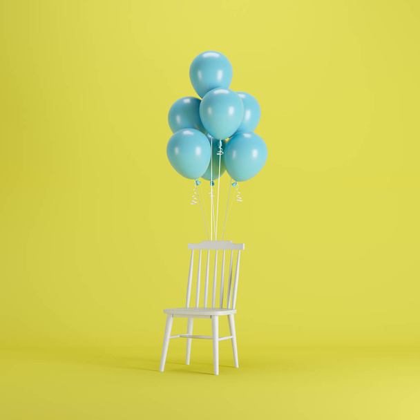 黄色の背景に浮かぶ青い風船を持つ木製の椅子。最小限のパーティーコンセプトアイデア. - 写真・画像