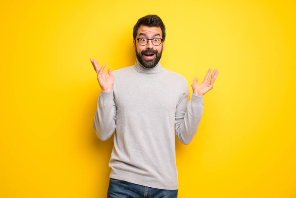 Man with beard and turtleneck with surprise and shocked facial expression - Photo, image