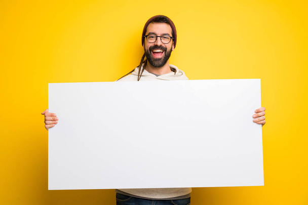 Hippie man with dreadlocks holding a placard for insert a concept - Photo, Image