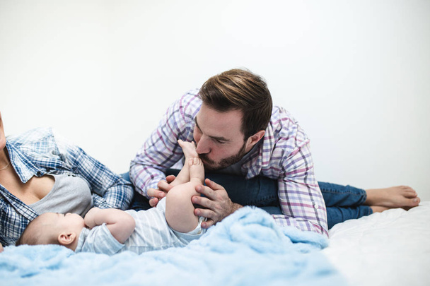Mother and father enjoying and relaxing with their baby boy.  - Fotografie, Obrázek