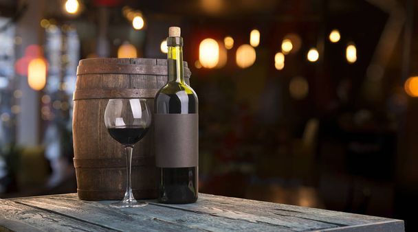 Expensive wine bottles collection and wooden barrel in the cellar, wine tasting and production concept - Photo, Image
