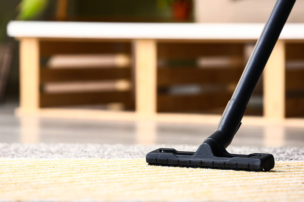 Brush of vacuum cleaner on carpet in room - Фото, зображення