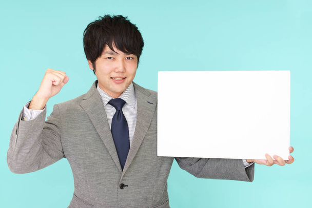 Smiling Asian businessman with a whiteboard - Photo, Image