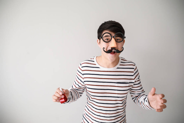 Αστείος Ασιάτης/ισσα άνθρωπος με διακόσμηση πάρτι για την Πρωταπριλιά ημέρα σε φως φόντο - Φωτογραφία, εικόνα