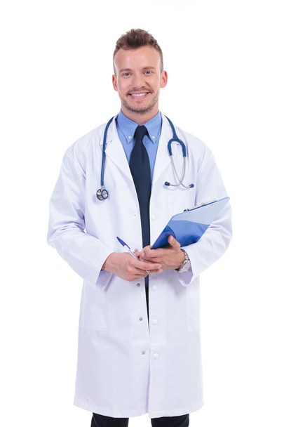 smiling doctor holding a pen and a clipboard - Foto, Imagem